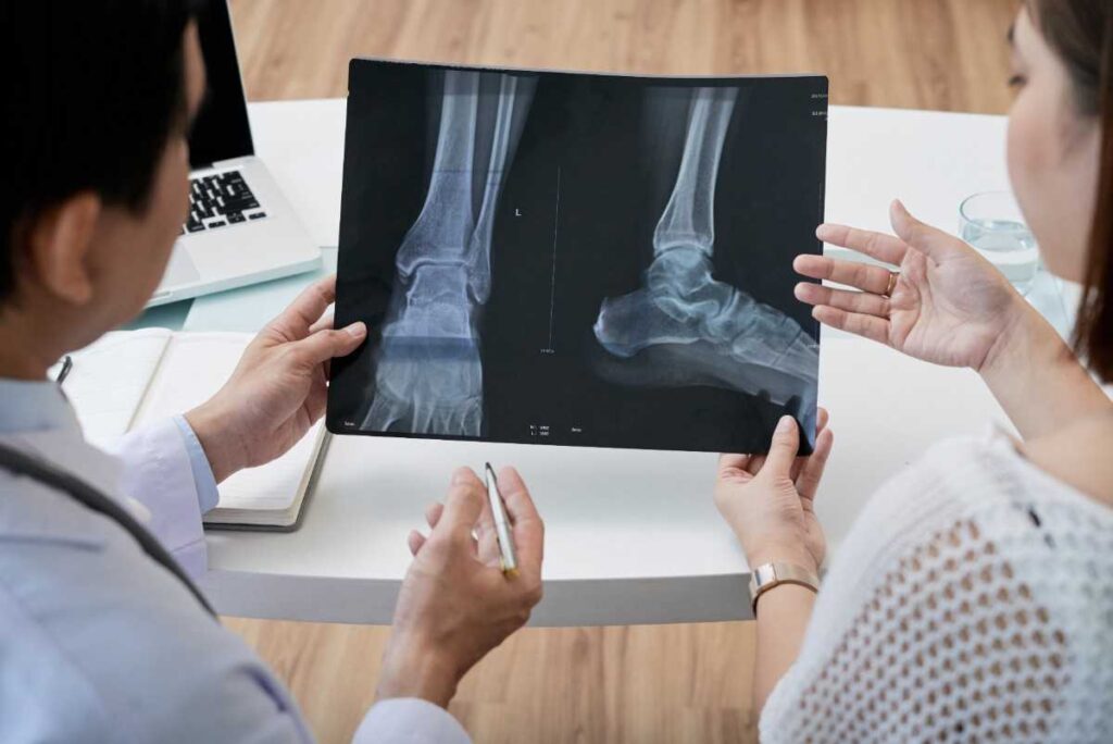 Experienced orthopedic specialist in Mangalore consulting a patient.